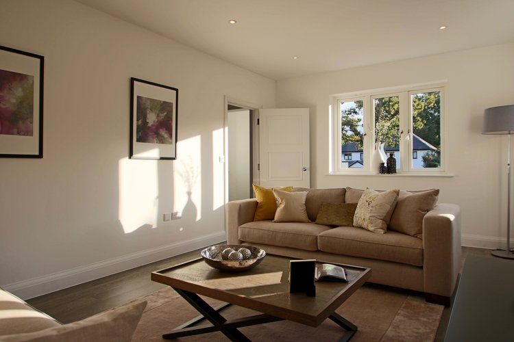 Remodelled family home lit at dusk with full-width glazing