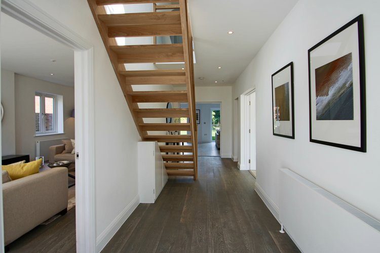 Bright hallway with open-tread oak staircase