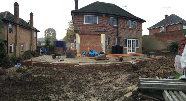 House under reconstruction with new roof structure and scaffolding