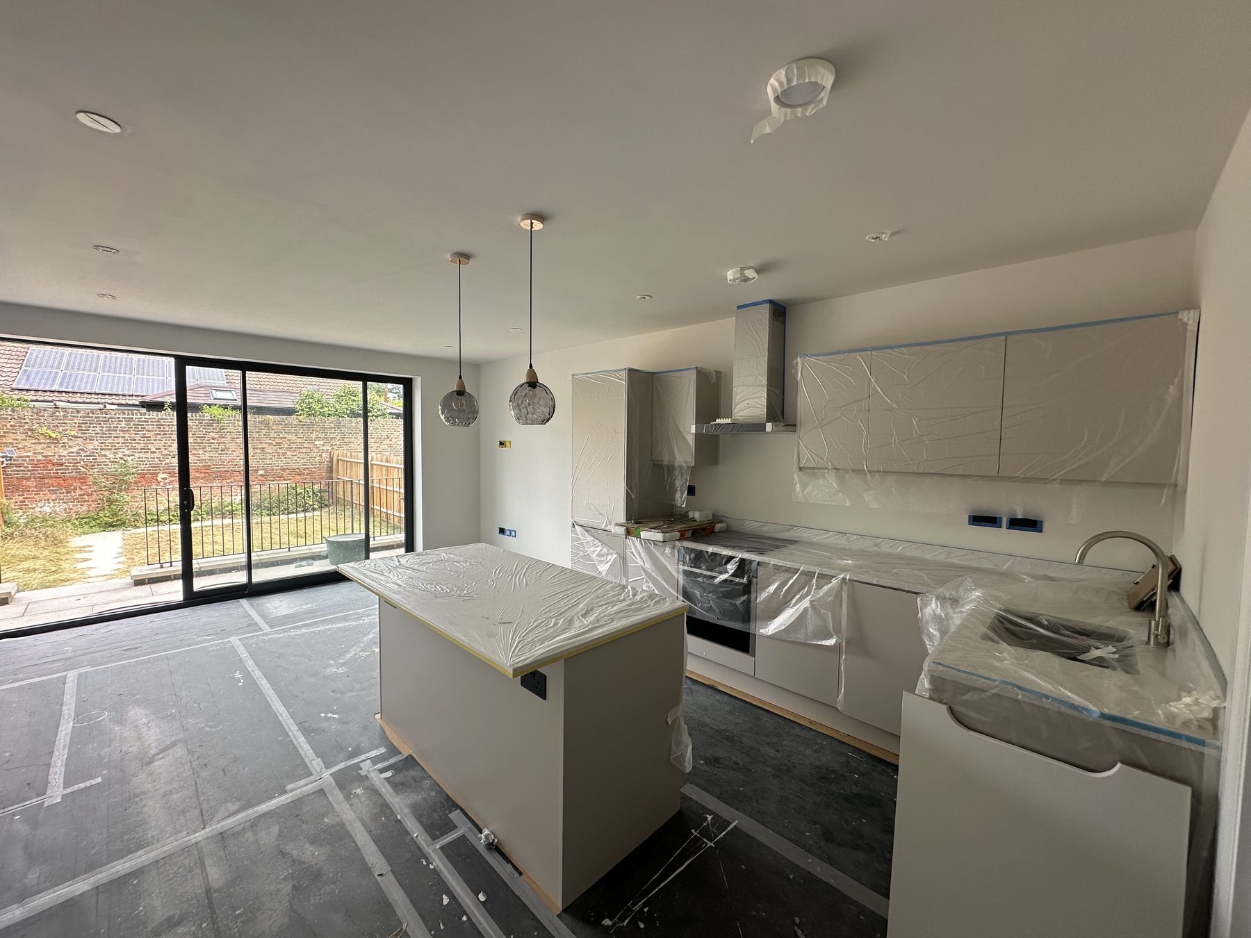 Kitchen with island in a new-build home during finishing