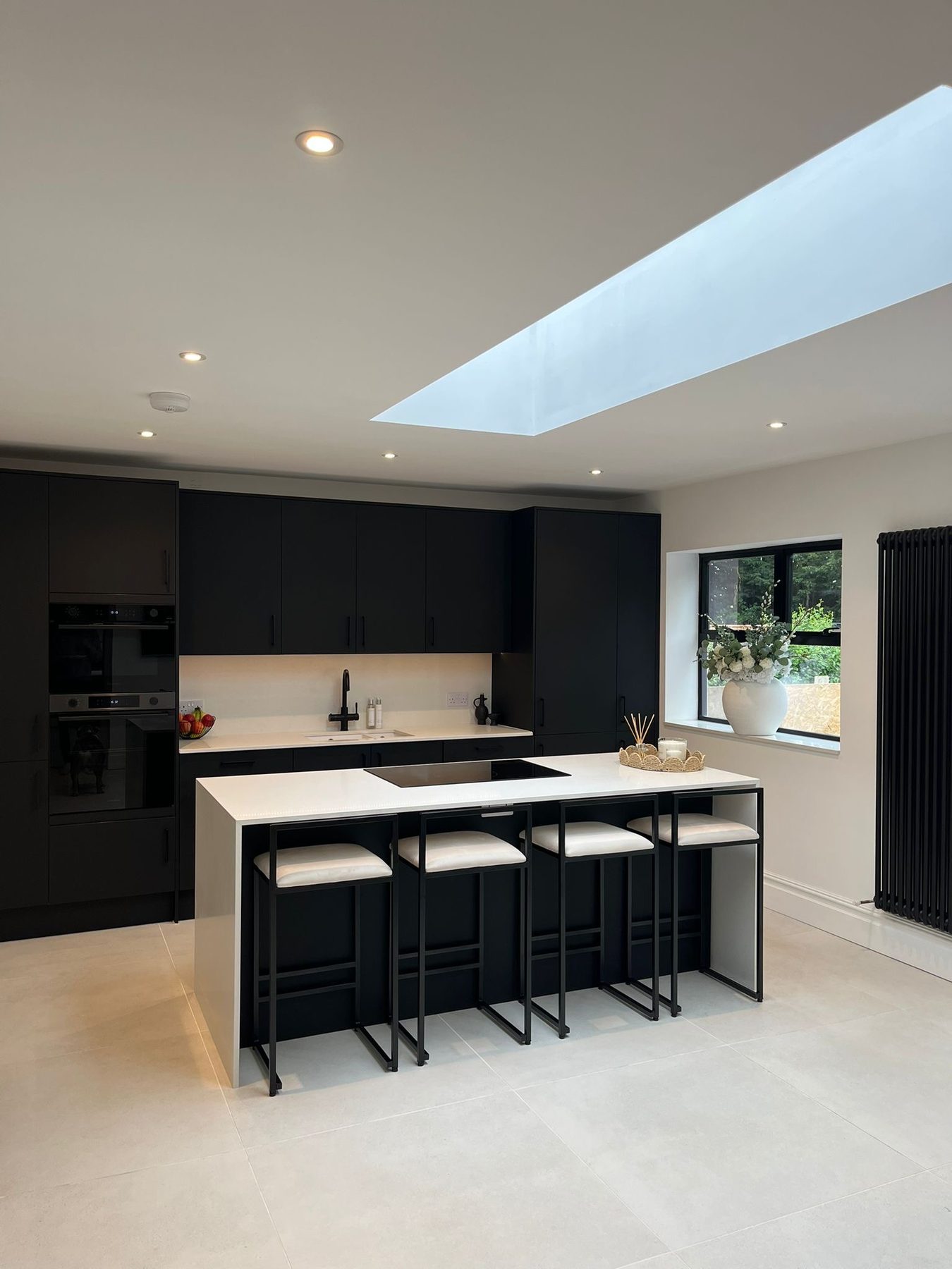Kitchen with island under a rooflight